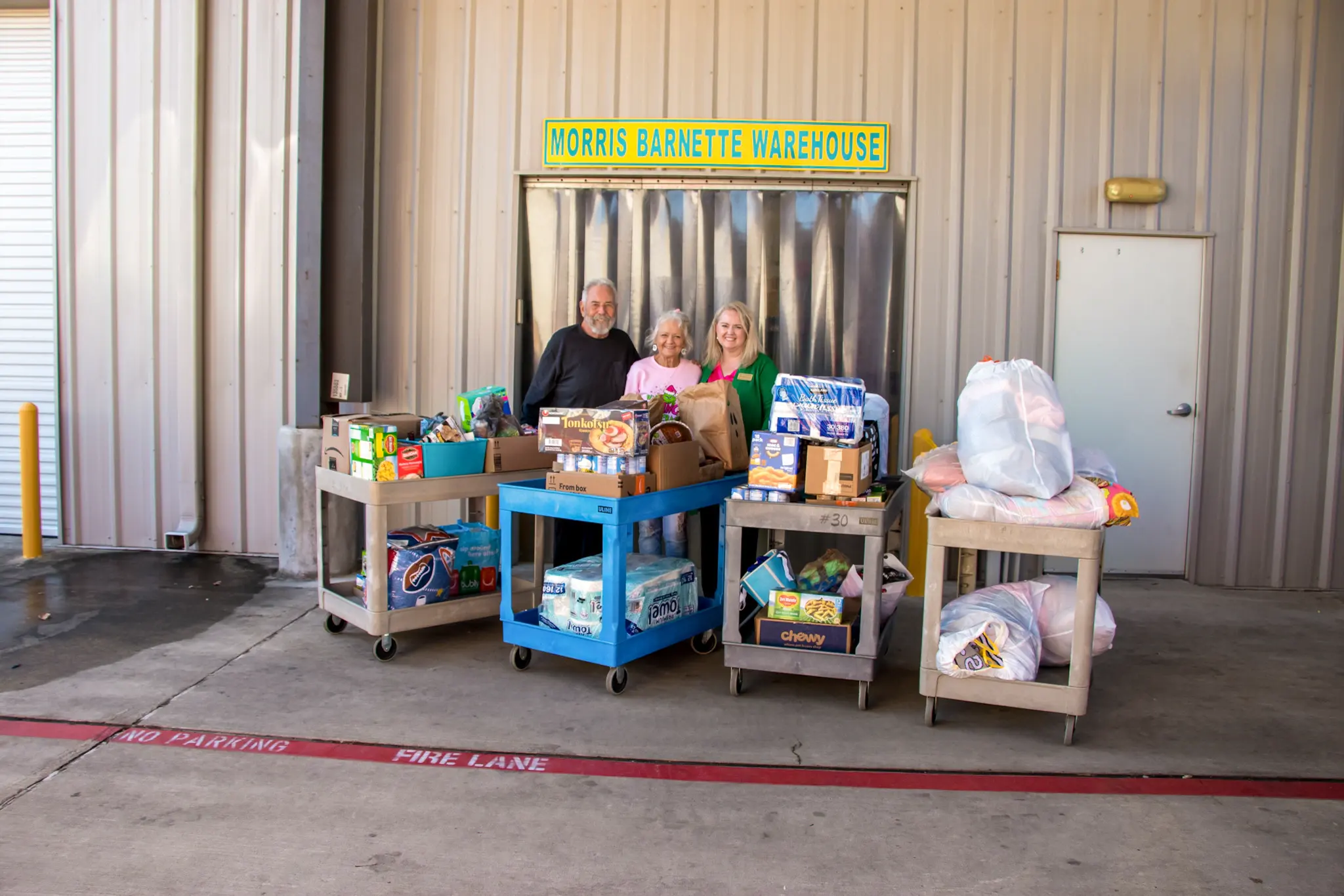 Volunteers with donated food outside the Morris Barnette Warehouse.